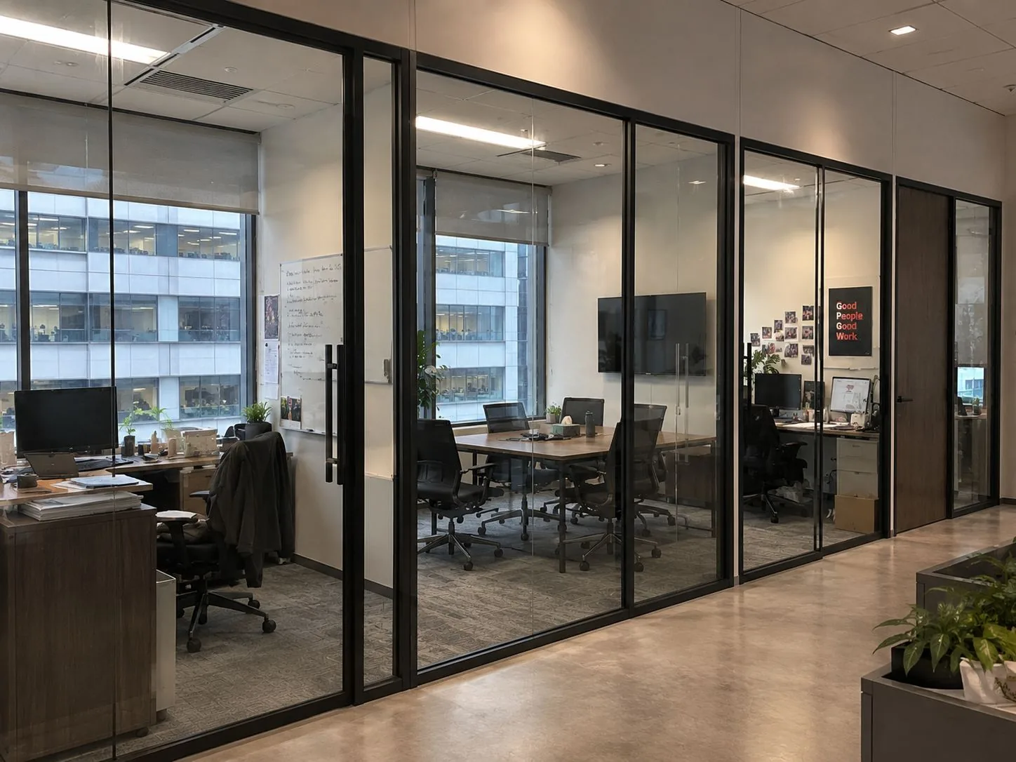 Office corridor lined with glass partition meeting rooms